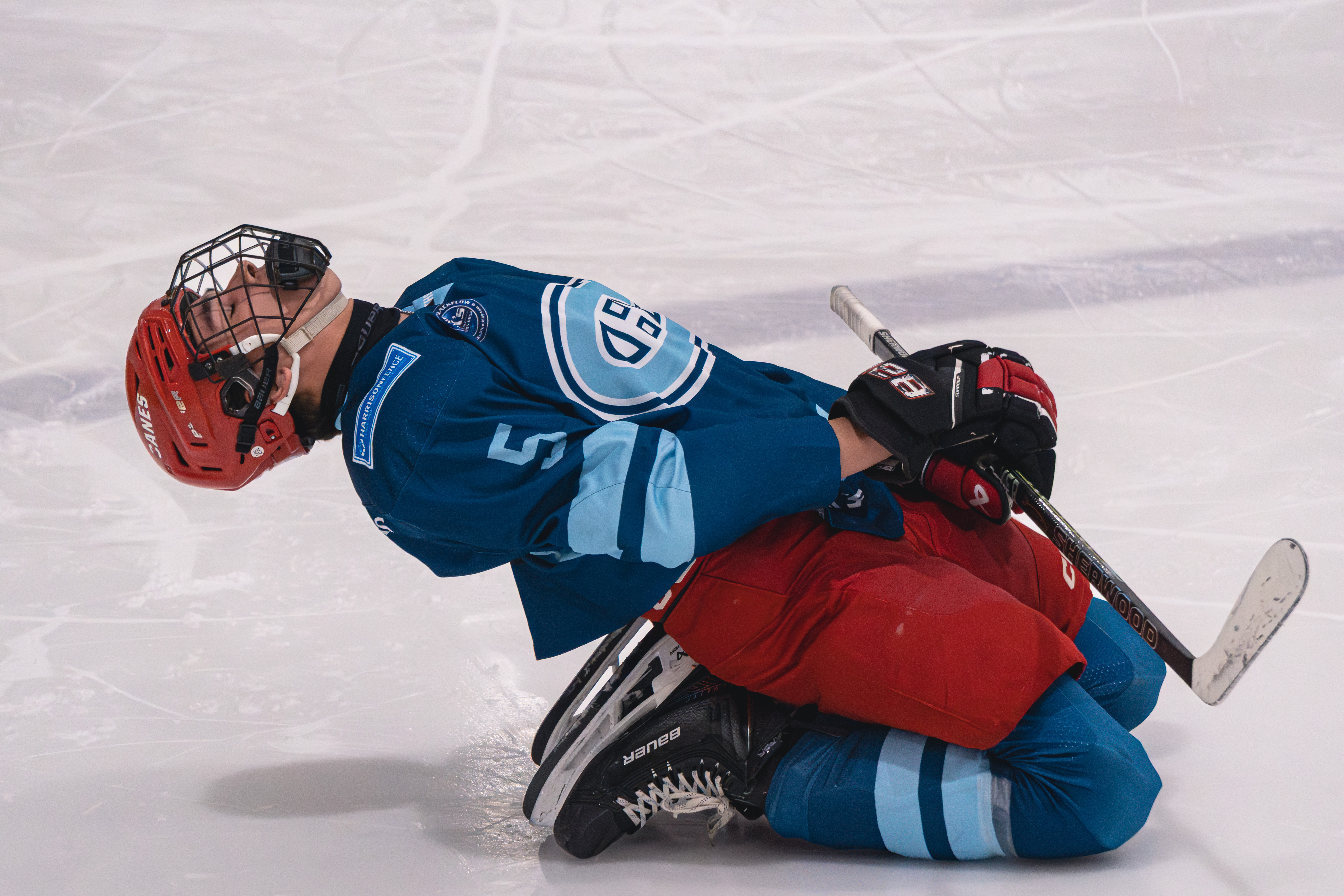 Wake Forest hockey player stretching on the ice before action resumes