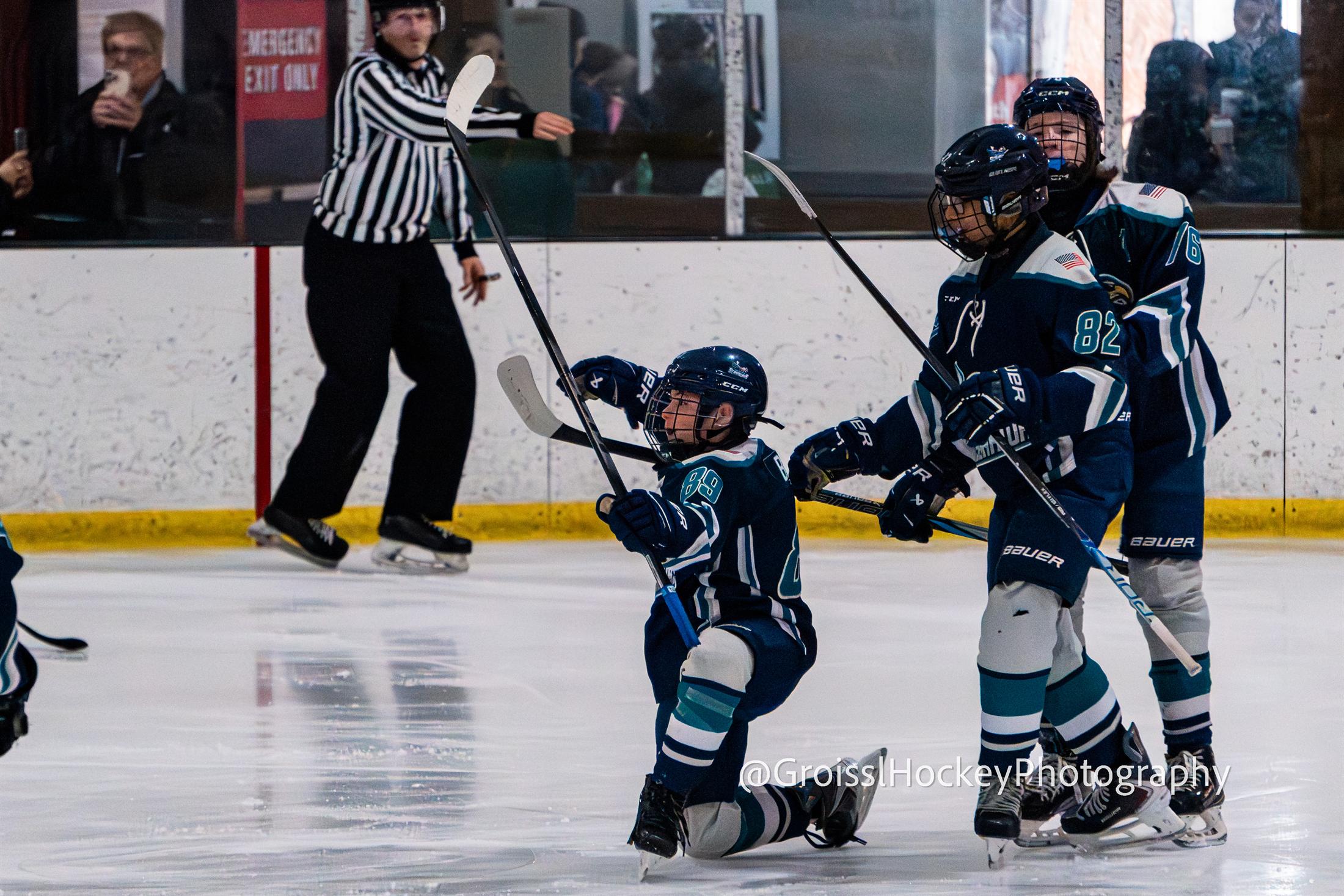 Game action with goalie and defenders in frame