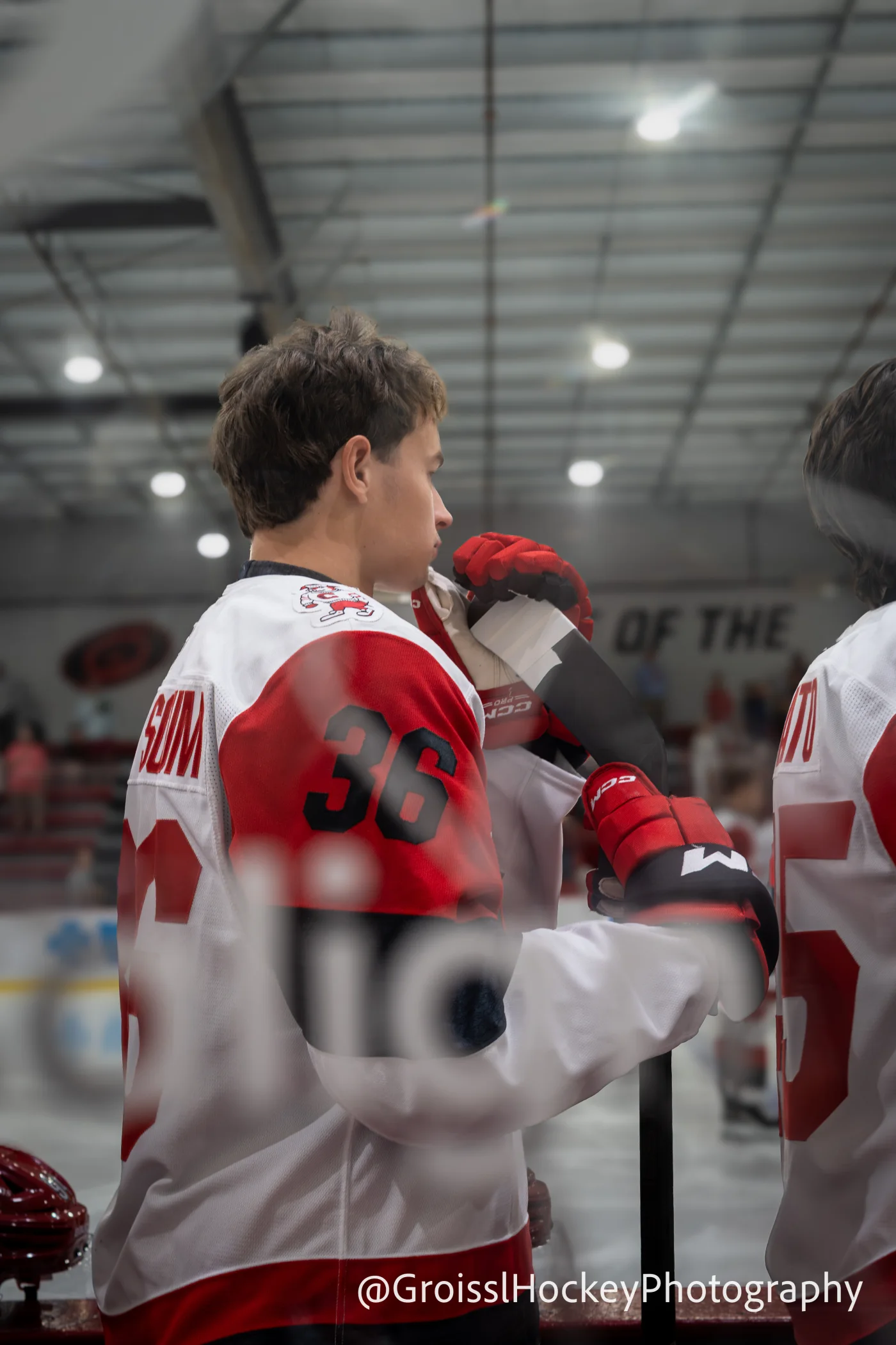 Felix Unger Sorum holding his stick at the Carolina Hurricanes bench