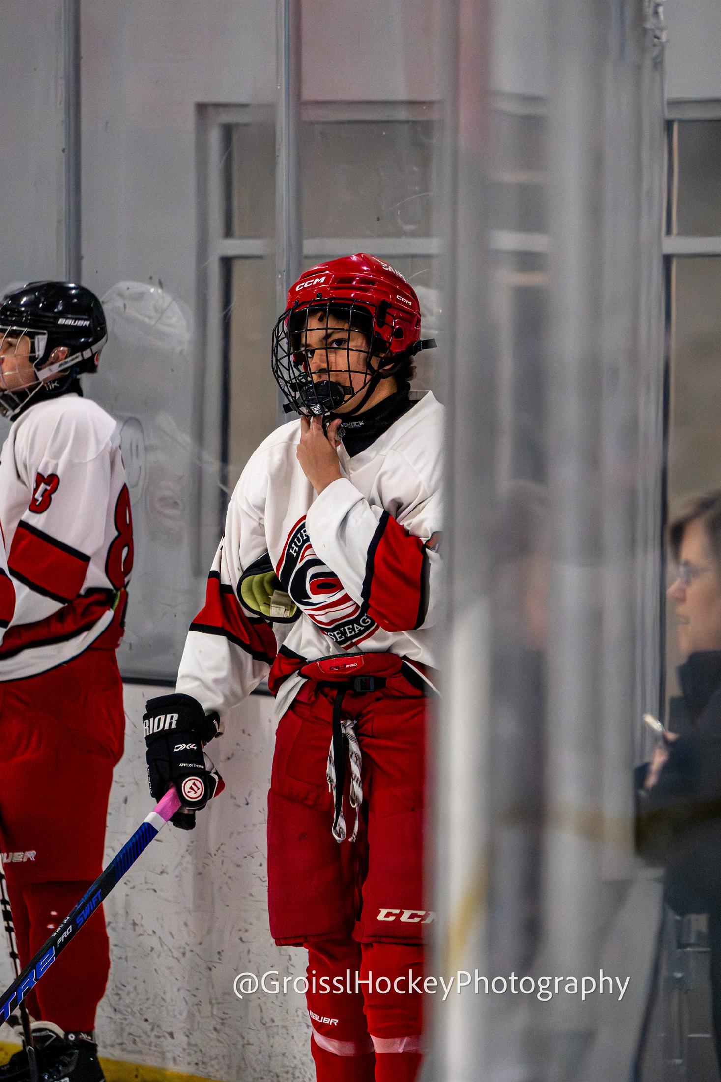 Player waiting at bench with focused expression