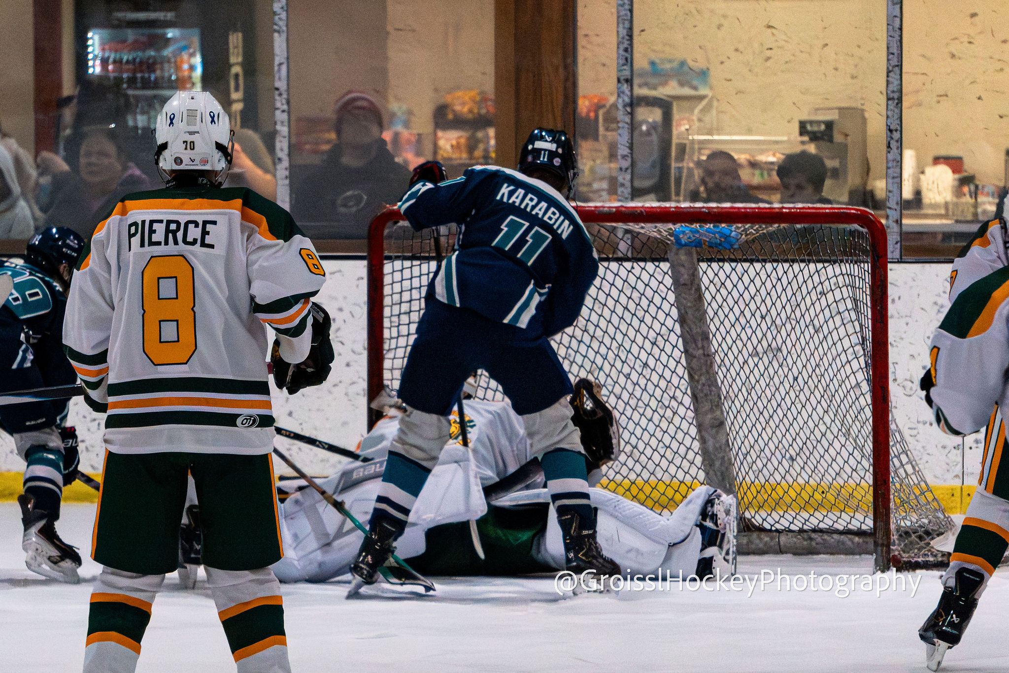 Jr. Seahawks players battling along the boards during 14U matchup