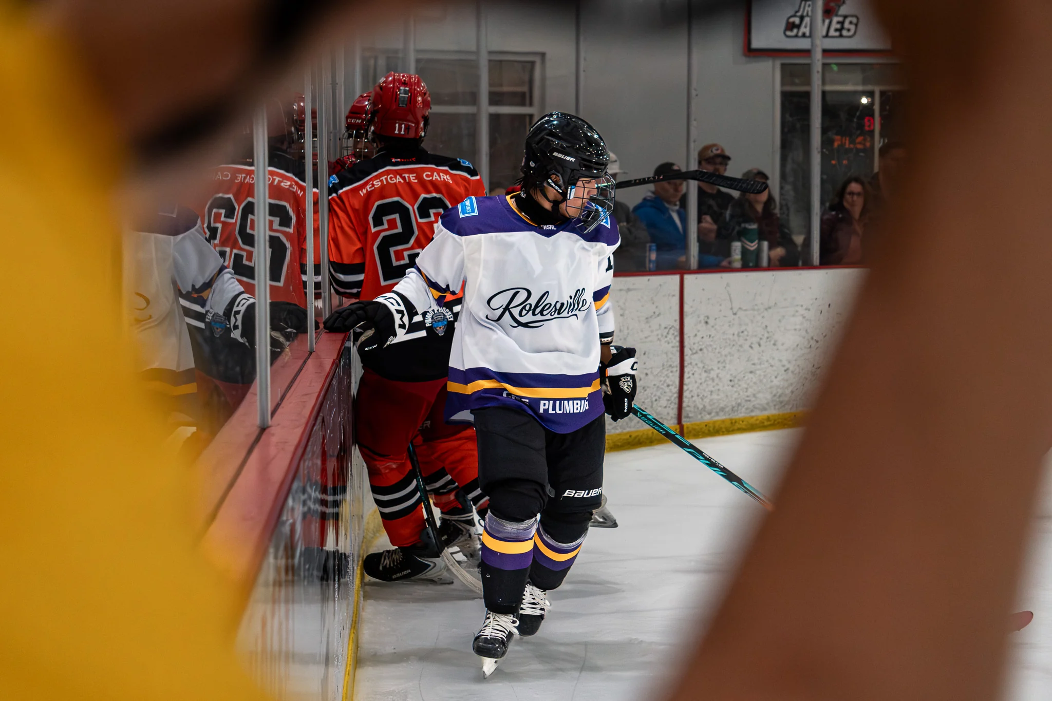 Team Rolesville skater gliding past the boards during THSHL game action
