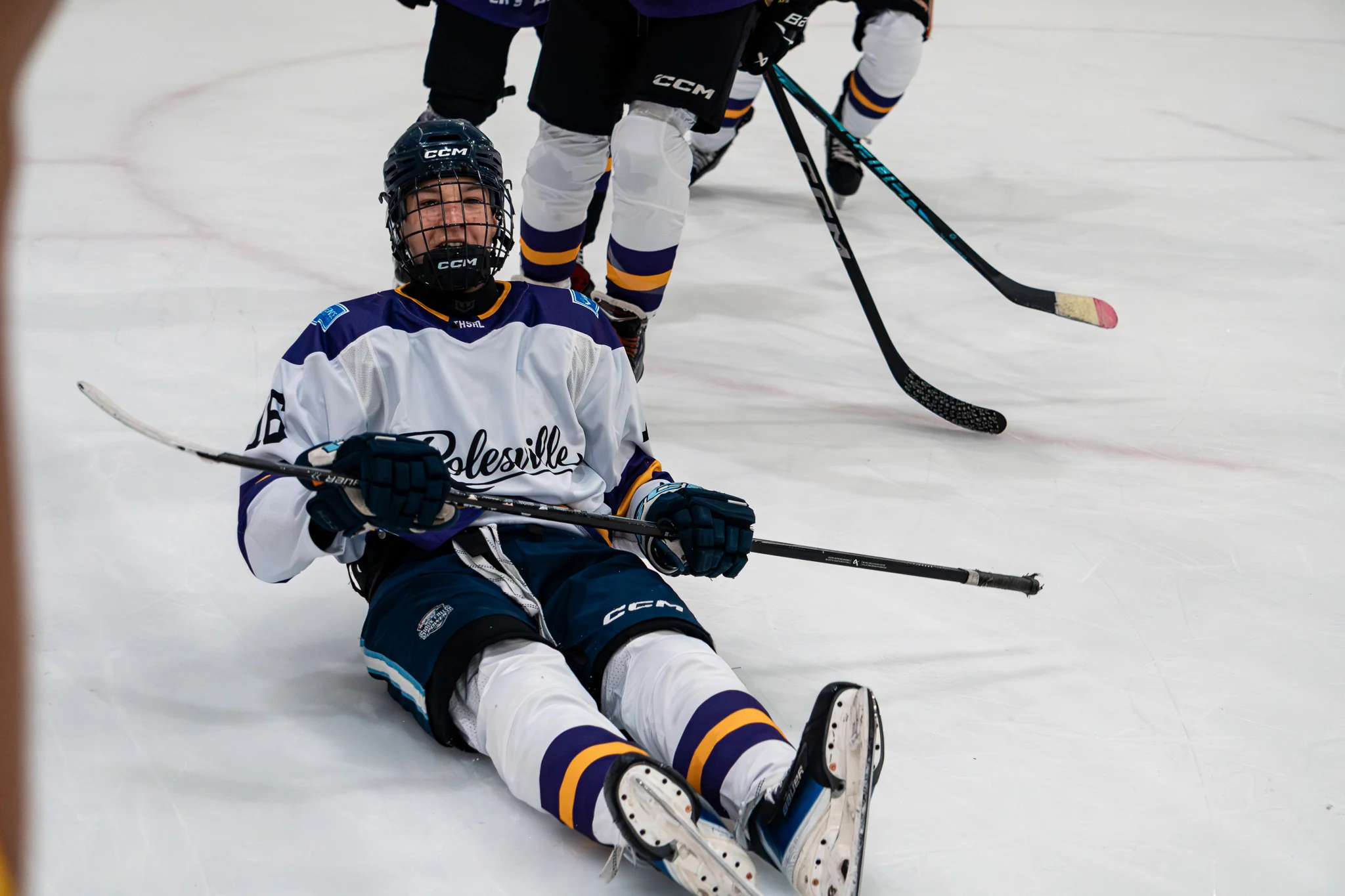 Team Rolesville player sitting on the ice after contact during the game