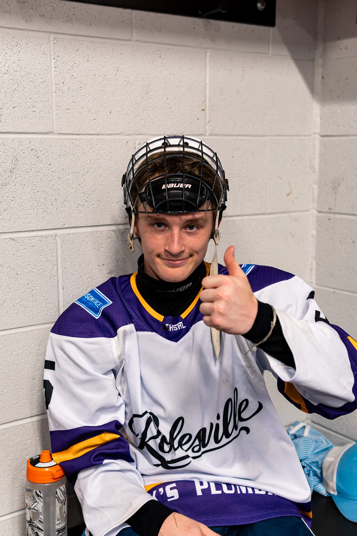 Team Rolesville player giving a thumbs up from the bench area