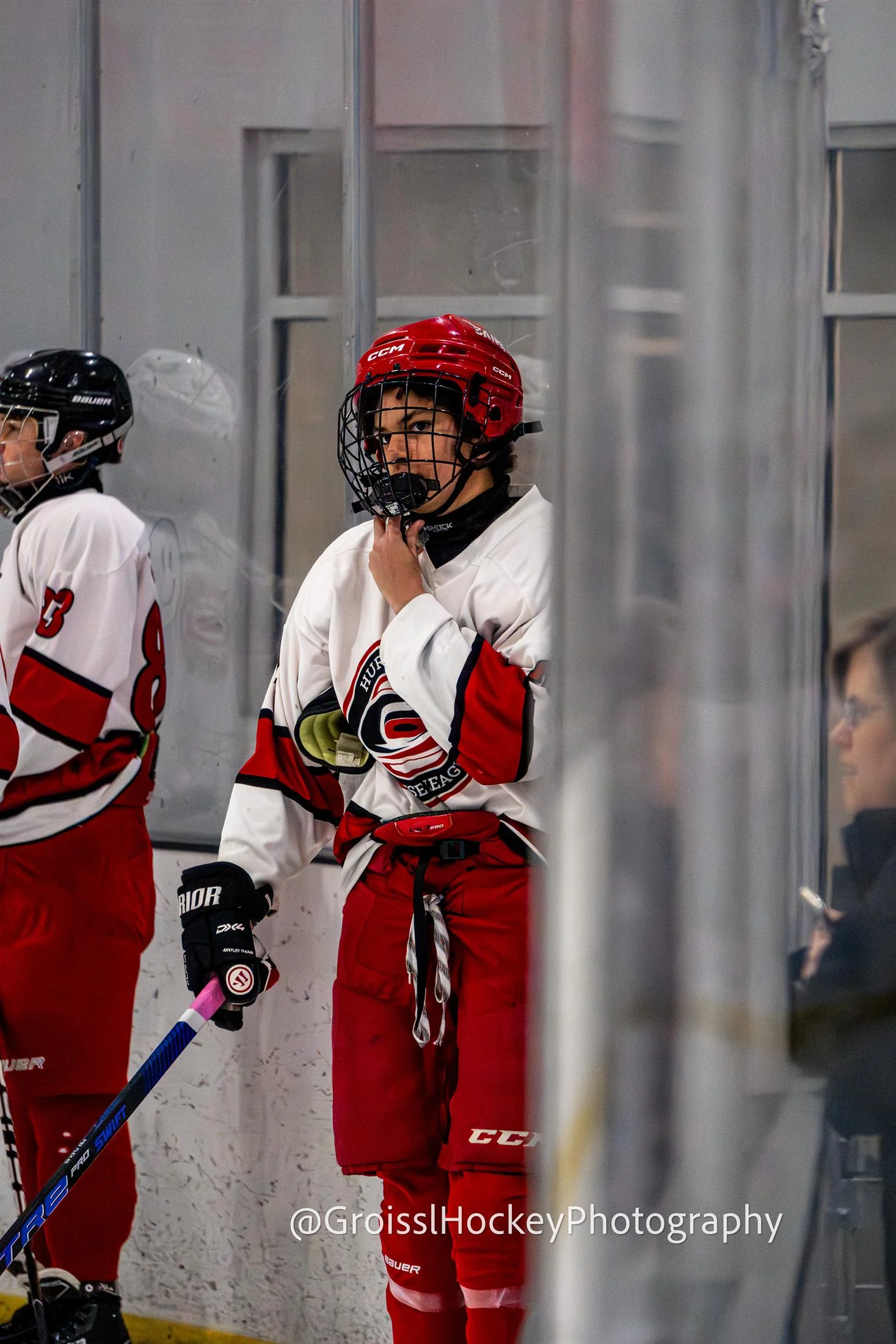 Player waiting at bench with focused expression